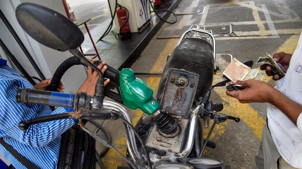 A pump attendant fills petrol in a bike at a fuel station in New Delhi, on 7 July 2021 | PTI