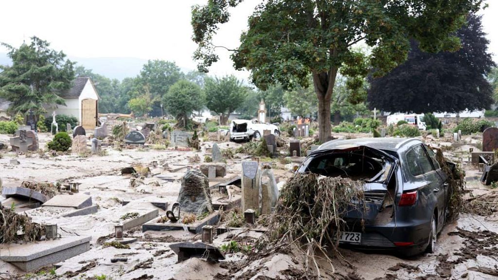 Flood water surrounds vehicles and grave stones in a cemetery in Bad Neuenahr-Ahrweiler, Germany, on 17 July 2021 | Photographer: Liesa Johannssen-Koppitz | Bloomberg