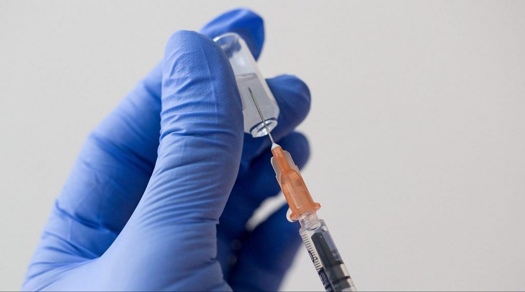 Representative Image | A health worker draws out a vaccine dose from a vial | Bloomberg