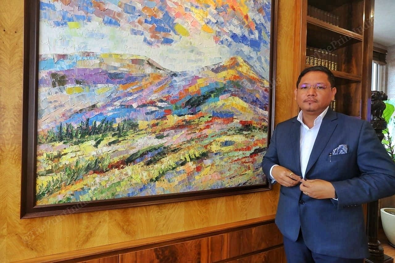 Chief Minister of Meghalaya Conrad Sangma standing in front of the painting at his office in Shillong | Photo: Praveen Jain | ThePrint