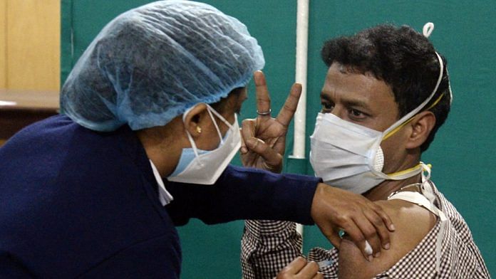 A doctor shows the victory sign as he is vaccinated against Covid-19 in Kolkata | Representational image | ANI