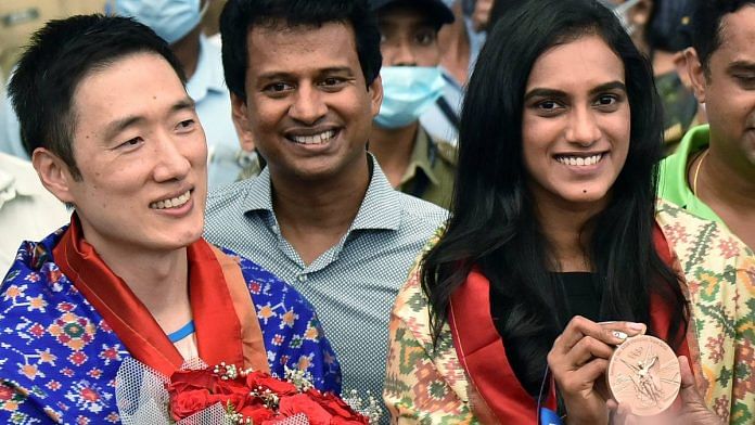 Olympic medalist P.V. Sindhu and her coach Park Tae Sang arrive at Rajiv Gandhi International Airport, in Hyderabad, from Tokyo, on 4 August | ANI