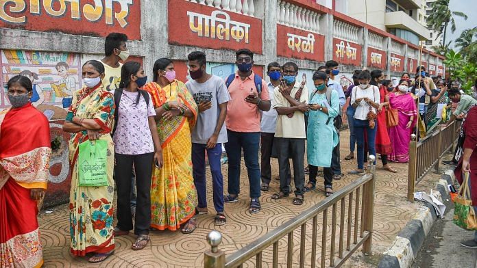 Beneficiaries wait in a queue to receive Covid vaccine dose, at a vaccination centre in Mumbai, on 12 August 2021 | Kunal Patil | PTI