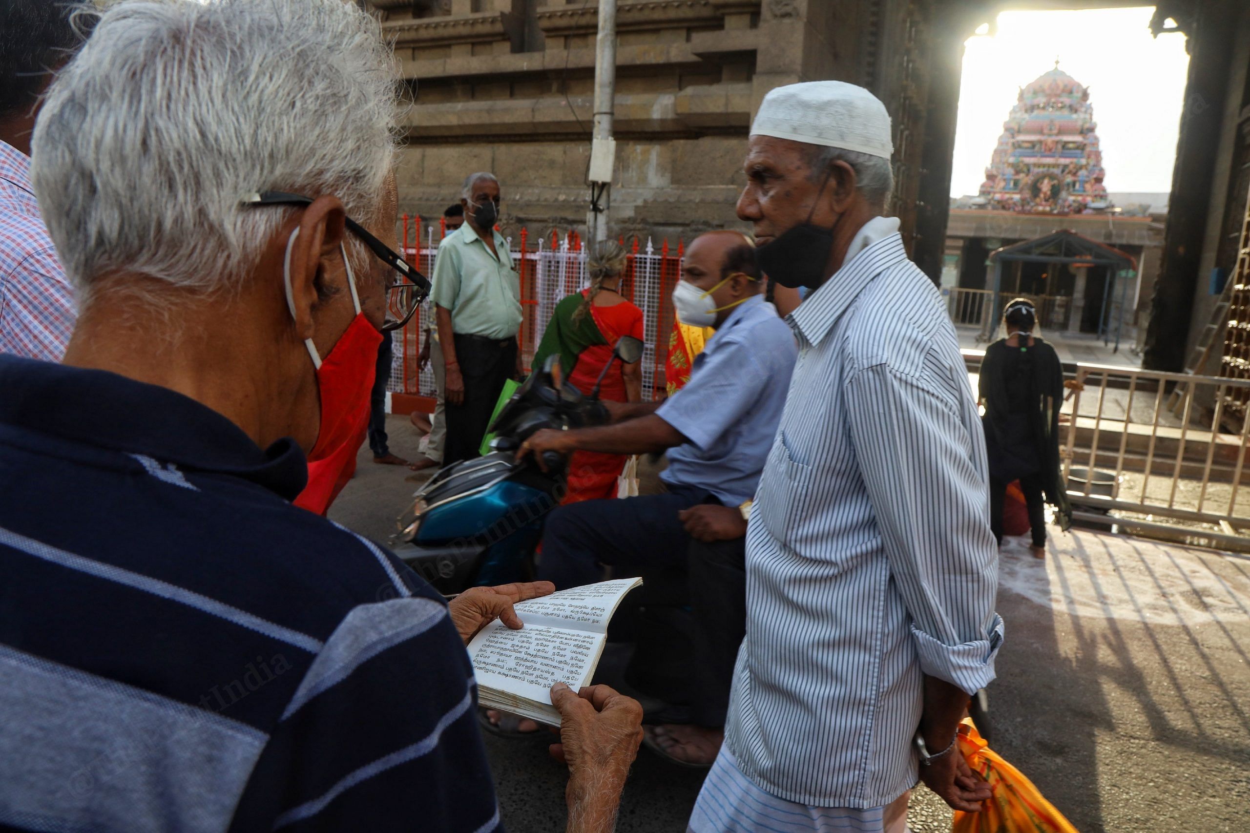 Before the opening of the temple, Natarajan prays from a shloka book. | Photo: Manisha Mondal/ThePrint