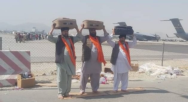 Afghan Sikh carrying the holy book Guru Granth Sahib at Kabul Airport