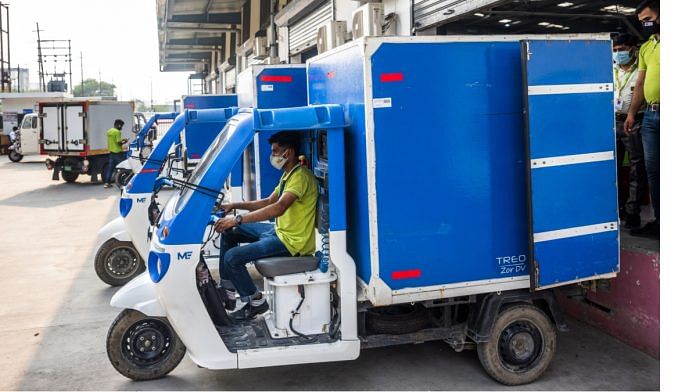 Saurav Saini prepares to make delivers in a Mahindra Treo Zor Ev at a BibBasket warehouse in Noida, India, on 28 June| Bloomberg