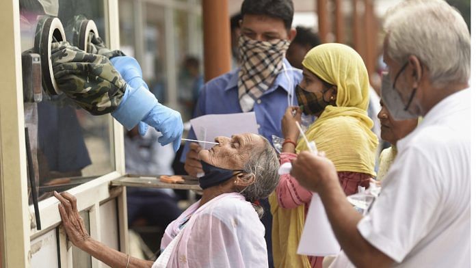 People wait to undergo Covid-19 testing at RML Hospital in Lucknow on 7 August 2021 | PTI