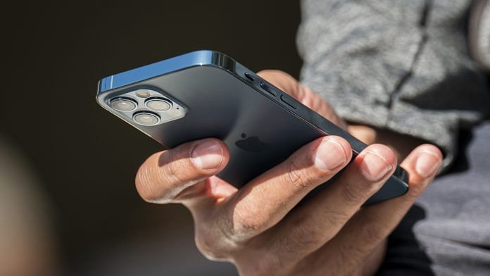 A person using an iPhone 12 Pro at an Apple store in San Francisco