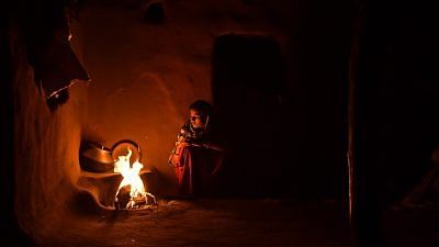 Representational image | A woman cooks food by fire inside a home in Kraska village, Rajasthan | Anindito Mukherjee | Bloomberg