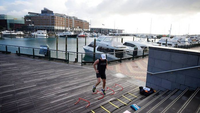A man exercises at a deserted marina during a nationwide lockdown in Auckland, New Zealand in August 2021 | Brendon O'Hagan | Bloomberg