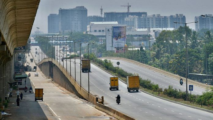 A partially deserted national highway is pictured during the weekend lockdown imposed as a preventive measure against the spread of the Covid-19 in Bangalore on 24 April 2021. Photographer: Manjunath Kiran/AFP/Getty Images via Bloomberg