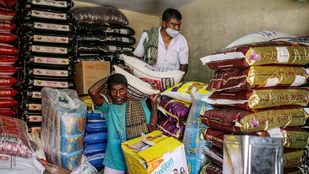 Representational image | Workers unload sacks of rice at a grocery store in Bengaluru in June 2021 | Dhiraj Singh | Bloomberg