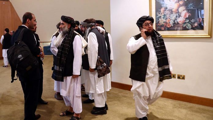 Members of Afghanistan's Taliban delegation ahead of an agreement signing between them and US officials in Doha, Qatar in February 2020| ANI via Reuters