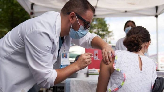 A healthcare worker administers a dose of the Pfizer-BioNTech Covid-19 vaccine to a student during a vaccination event at a school in Boston, Massachusetts, US | Allison Dinner | Bloomberg