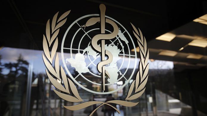 The World Health Organization emblem sits on a glass entrance door at the WHO headquarters in Geneva, Switzerland