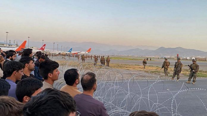 People at Kabul airport as US soldiers stand guard on 16 August 2021|Representational Image| Getty Images via Bloomberg