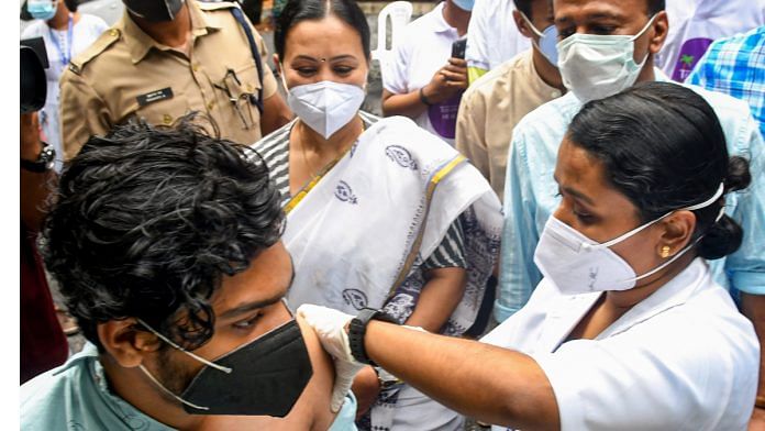 Covid Vaccination A medic administers a dose of Covid-19 vaccine to a beneficiary in the presence of Kerala Minister for Health Veena George on 19 August 2021 | PTI