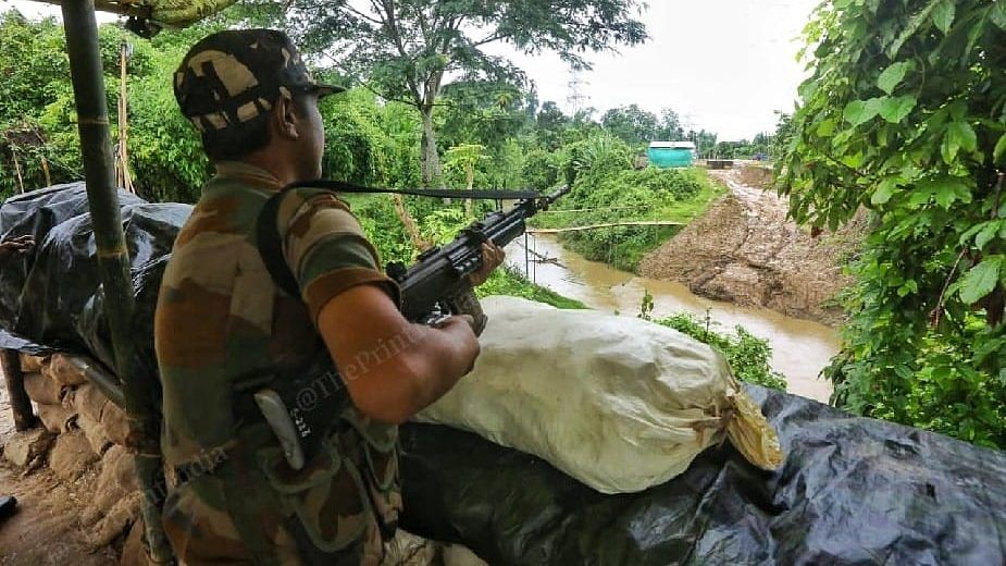 A Mizoram Police personnel keeps an eye on the Assam post | Photo: Praveen Jain/ThePrint