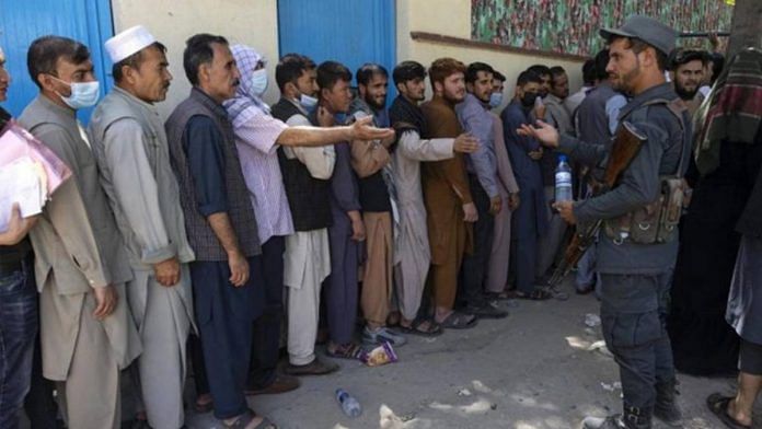 Representative Image | Afghans queue up at the passport office in Kabul on 14 August | Bloomberg