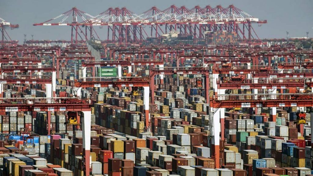 Shipping containers next to gantry cranes at the Yangshan Deepwater Port in Shanghai, China | Photographer: Qilai Shen | Bloomberg