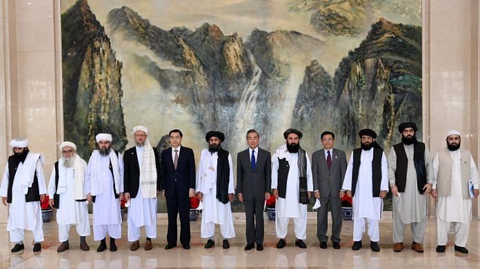China's Foreign Ministry officials along with the Taliban delegation pose for a photo during their meeting in China, on 28 July 2021 | Twitter/@MFA_China