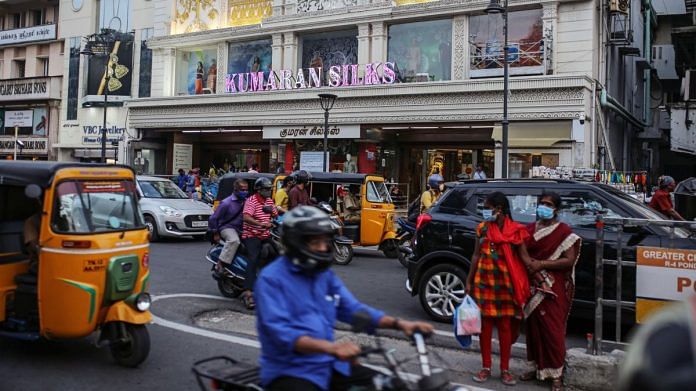 Vehicles travel past stores in Chennai | Representational image | Photographer: Dhiraj Singh | Bloomberg