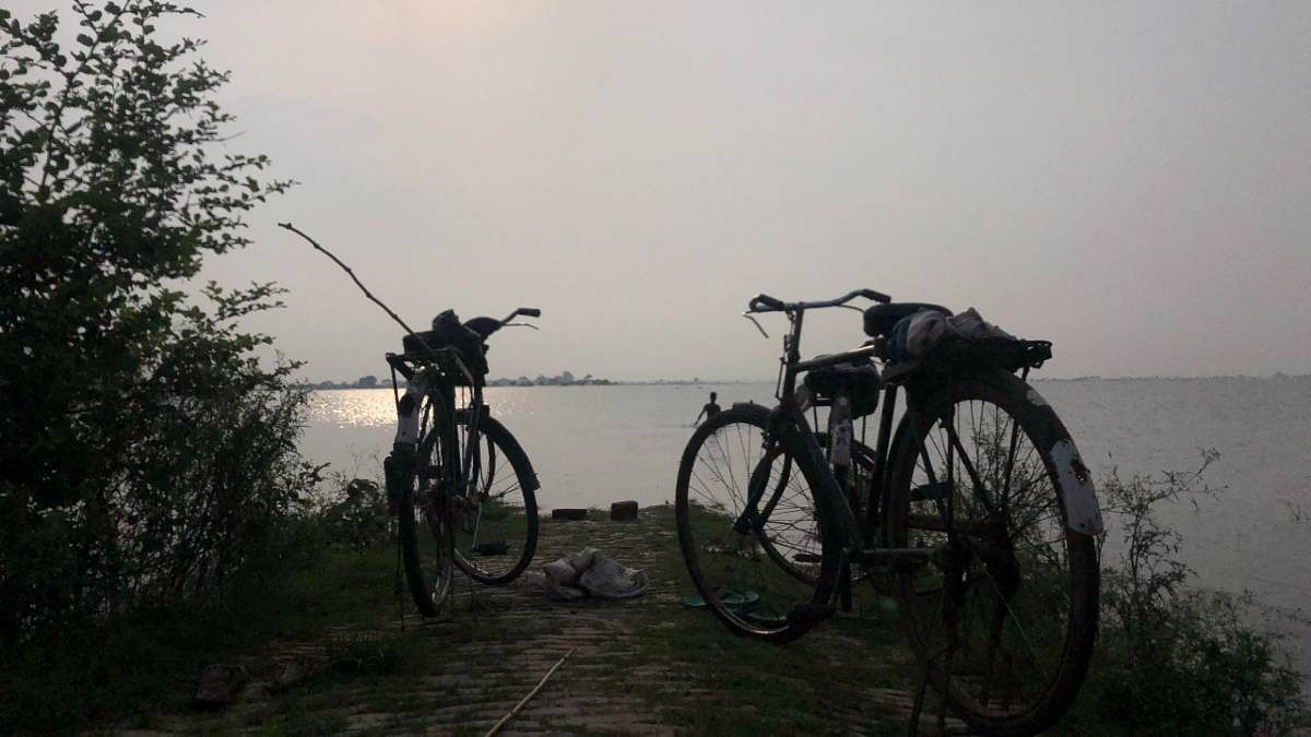 Cycles stand abandonded, as a plucky youngster in Gorakhur — along with his neighbours — dives into the flooded river, with the hope of catching fish that he can then sell to earn some money for his family. 