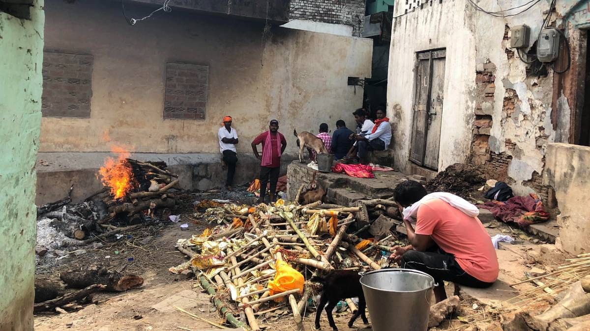 In Varanasi, a man bids farewell to his mother. With the city's Manikarnika Ghat — known for its ever-burning funeral pyres flooded — make-shift arrangements for cremations were being made in the lanes leading to the ghat.