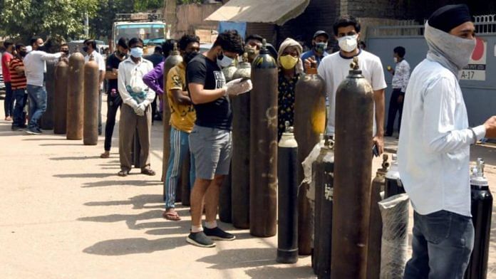 File photo of people waiting to refill their medical oxygen cylinders for Covid patients at an oxygen refilling factory in New Delhi | R Raveendran | ANI