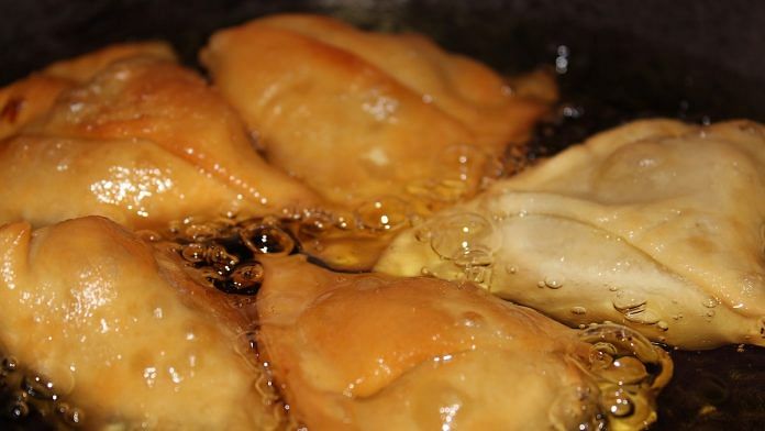 Samosas frying in oil