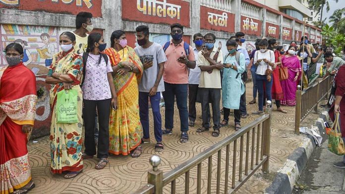 File photo of people waiting in queue in Mumbai to receive their Covid vaccine doses | Representational image | PTI