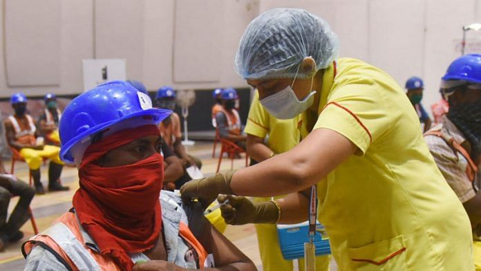 Representational image of a construction worker being vaccinated against Covid-19 | Photo: ANI