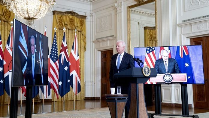 US President Joe Biden (centre) flanked by screens featuring Australian PM Scott Morrison (left) and UK PM Boris Johnson at the announcement of the new AUKUS partnership | Photo: Bloomberg