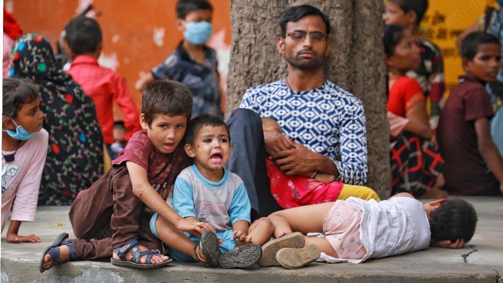 Parents and children wait outside the district hospital in Firozabad | Manisha Mondal | ThePrint