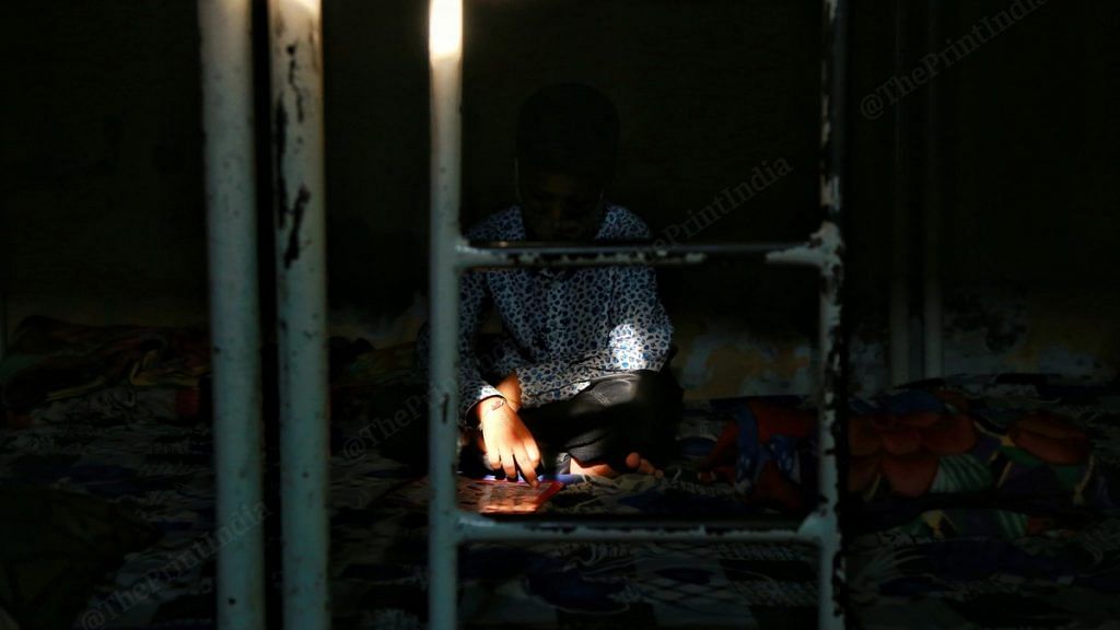 A rescued child labourer reads a book at a shelter home | Photo: Manisha Mondal | ThePrint