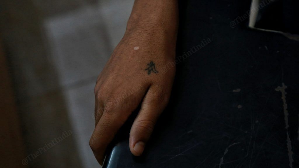 A tattoo reading 'maa' in Hindi on a child's hand. The child now works in a restaurant, after his mother lost her job due to the Covid-19 pandemic | Photo: Manisha Mondal | ThePrint
