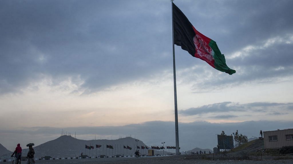 An Afghan flag flying on a hilltop in Kabul | File photo: Victor J. Blue | Bloomberg