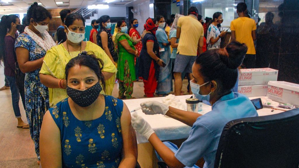 Representative image | A health worker administers a dose of Covid-19 vaccine to a beneficiary, at District hospital in Noida on 28 September 2021 | PTI
