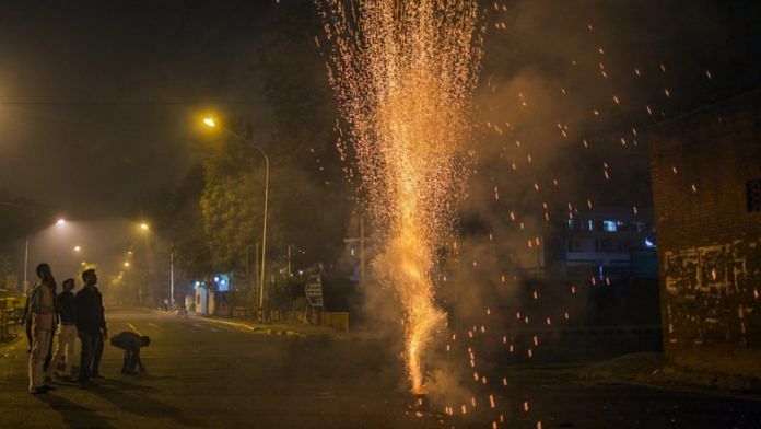 Revelers watch a firework during Diwali celebrations in Delhi | Representational Image| Prashanth Vishwanathan/Bloomberg