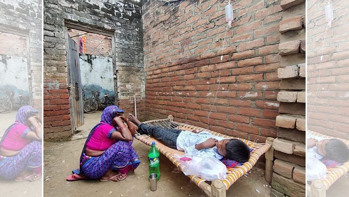 A mother sits by her child, suffering from viral fever, as he receives an intravenous drip at a quack's 'clinic' in Firozabad city | Shubhangi Misra | ThePrint