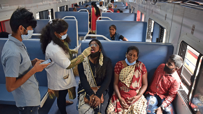 A healthcare worker collects a swab sample of a woman for the Covid test inside a train compartment, in Bengaluru on 6 Sep 2021 | ANI