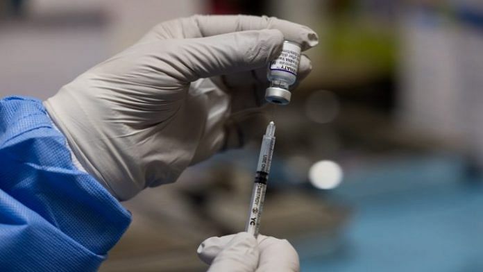 A nurse fills a syringe with a dose of the Pfizer-BioNTech Covid-19 vaccine | Photographer: SeongJoon Cho | Bloomberg