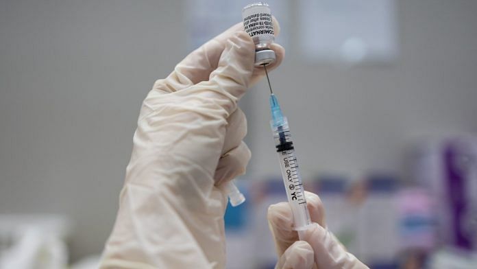 A nurse fills a syringe with a dose of the Pfizer Inc.-BioNTech SE Covid-19 vaccine | Bloomberg