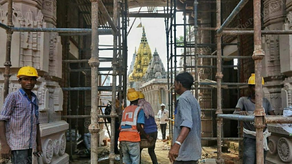 Workers constructing a new gateway to the Kashi Vishwanath Temple (golden spire) in Varanasi | Photo: Praveen Jain | ThePrint