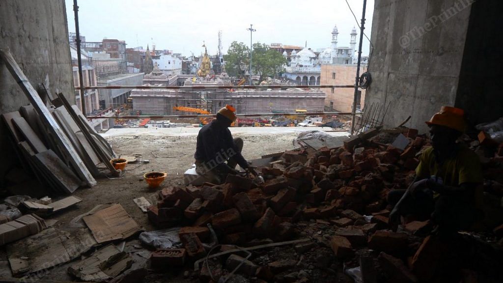 A worker at one of the new facilities being constructed for Kashi Vishwanath pilgrims | Photo: Praveen Jain | ThePrint