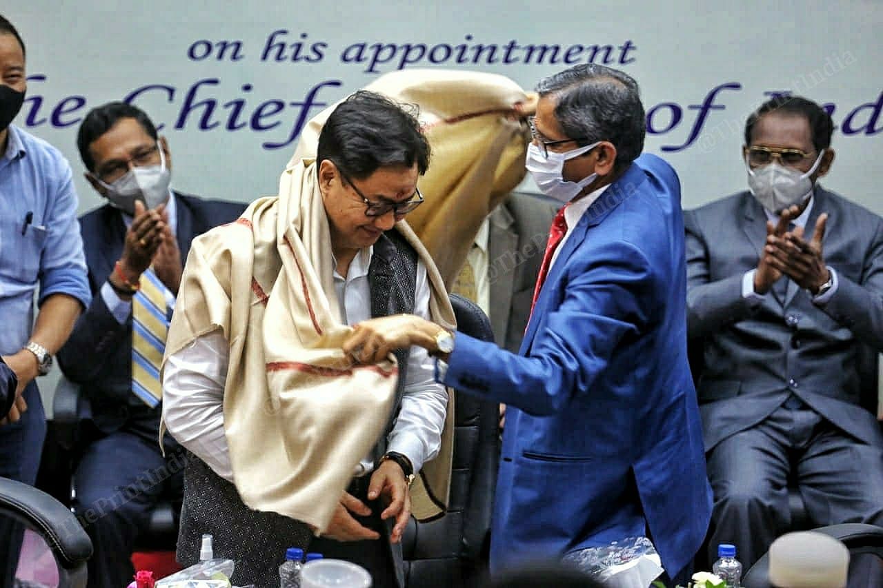 Chief Justice of India NV Ramana greets Law Minister Kiren Rijiju by presenting him a shawl during an event organized by the Bar Council of India.  Praveen Jain |  impression