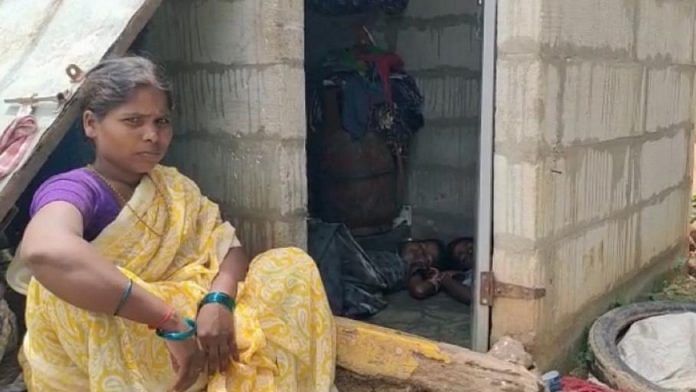 Sujatha sits outside the toilet while her children sleep inside | By special arrangement