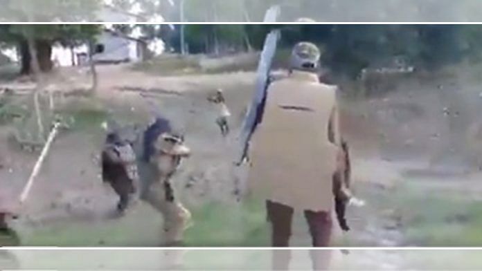 Screenshot from a grainy video of police firing at a lathi-wielding protester during the clashes in Darrang district's Dholpur village last week | Via Twitter