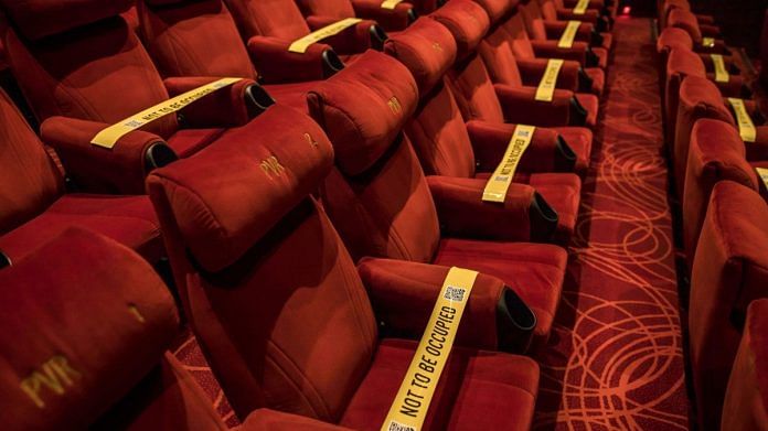 Tape is displayed on seats to implement safe distancing measures at a film theater in the PVR Icon cinema at the DLF Promenade Mall in New Delhi | Photographer: Anindito Mukherjee | Bloomberg