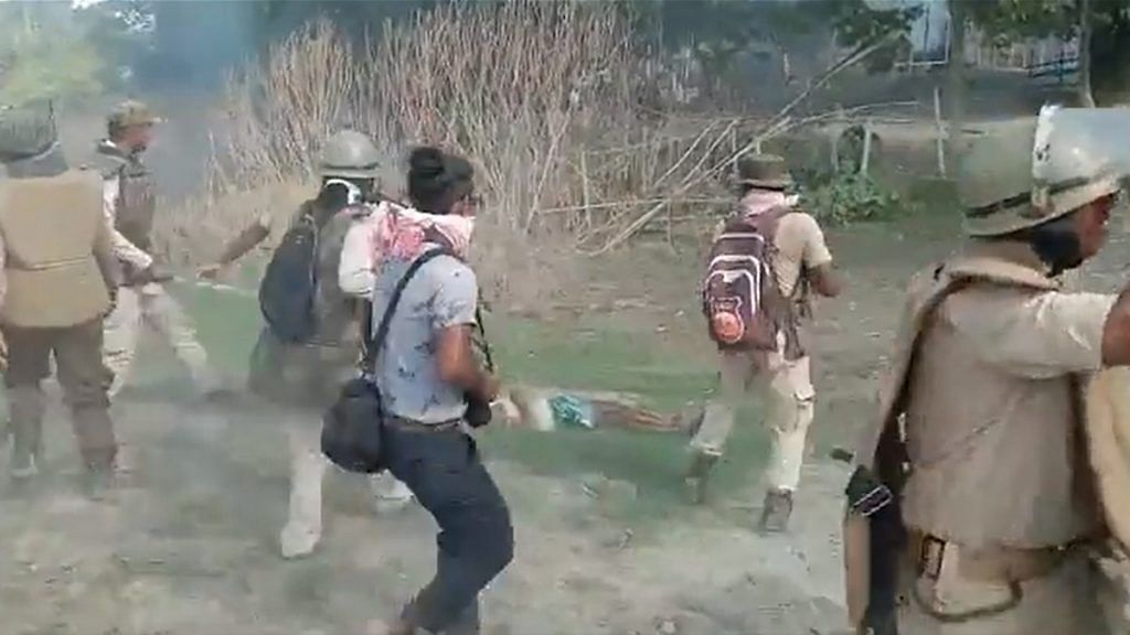 A screenshot from a purported video of the clashes between locals and police personnel in Assam's Darrang district on 23 September 2021. | Photo: Twitter/AshrafulMLA